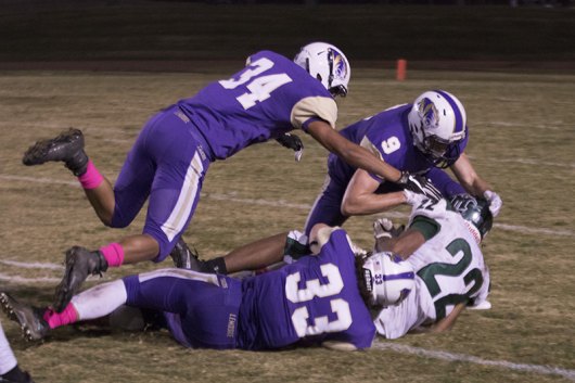 Lemoore's Chris Herrera (34), William Kloster (33) and Jack Foot (9) helped lead a solid defense Friday night against visiting El Diamante.